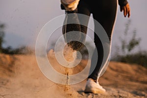 Female runner running on a forest trail. Woman athlete jogging in the mountain. Workout wellness concept