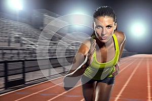 Female runner sprinter exercising and training intense track and field athlete determination for greatness in sports