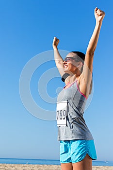 Female runner with start number showing winning attitude.