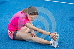 Female runner stretching before competition