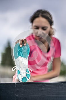 Female runner stretching before competition