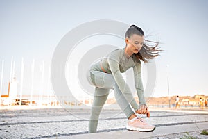 Female runner stretching before running