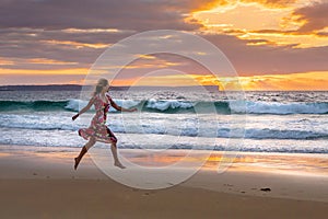 Female running along the beach in wet sand