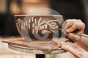 female s hand carving paint bowl. High quality photo