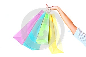 Female's hand holding colorful shopping bags photo