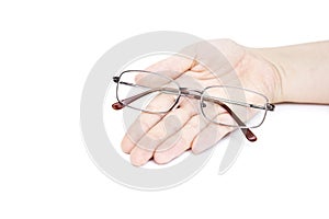 Female`s hand holding glasse on white background. Glasses in han