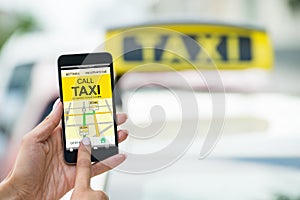Female`s Hand Holding Mobile Phone Booking Taxi