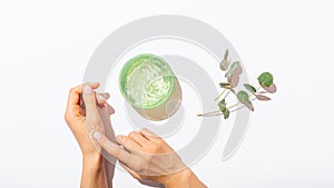 Female's hands applying aloe vera gel