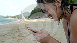 Female's Hands Using Black Smartphone on Sea Water Background