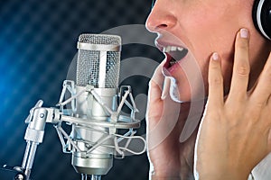 Female`s Open Mouth With Red Lipstick In Front Of Microphone