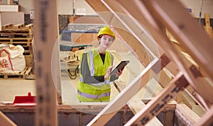 Female Safety Inspector With Digital Tablet At Construction Site