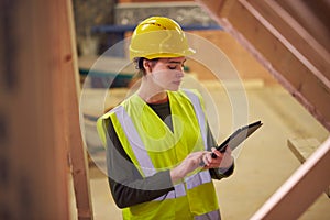 Female Safety Inspector With Digital Tablet At Construction Site