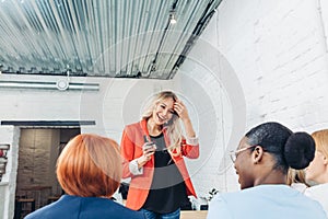 Female Sales Consultant telling about new goods to young business women