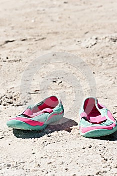 Female, sandles in the sand of a tropical beach