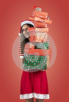 Female Santa holding pile of presents