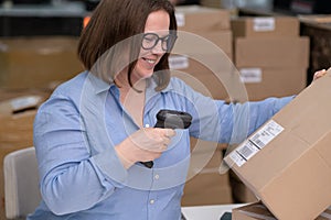 female scanning barcode on box quality control for online sales, SME online shop e-commerce concept