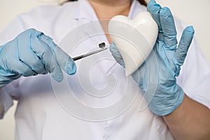 female scientist, doctor holding heart model, microprocessor, microchip, biochip tweezers for immunocytochemical studies heart,