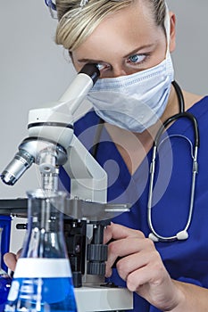 Female Scientist Doctor in Laboratory Using Microscope