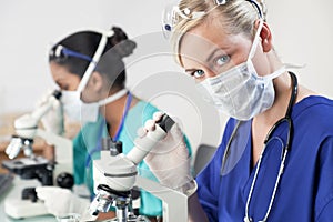 Female Scientist or Doctor Using Microscope