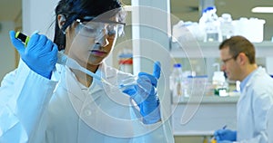 Female scientist experimenting in laboratory 4k