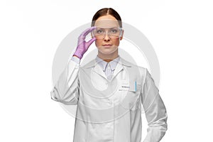 Female scientist in goggles and gloves