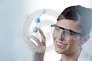 Female scientist holding molecular model