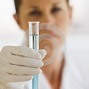 Female Scientist holding up Test Tube