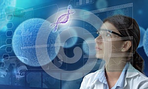 Female scientist looking at dna helix in a scientific screen display