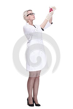 female scientist looking at liquid in a lab flask . isolated on a white background.