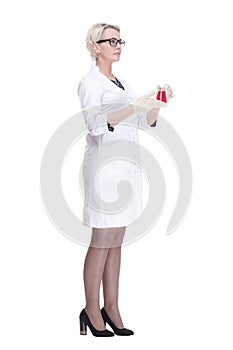 female scientist looking at liquid in a lab flask . isolated on a white background.