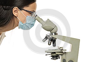 Female scientist looking through a microscope, close up