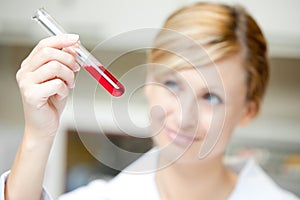 Female scientist looking at a test tube