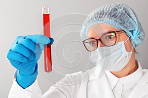 Female scientist looking at a test tube in a laboratory