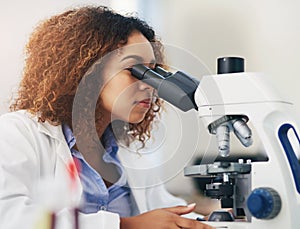 Female scientist, microscope and analyse in laboratory for research or medical breakthrough. Health, data and specialist photo