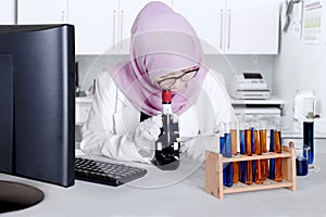 Female scientist with microscope in the lab