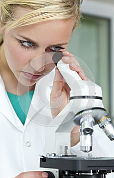 Female Scientist & Microscope in Laboratory