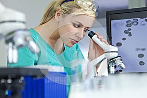 Female Scientist & Microscope in Laboratory