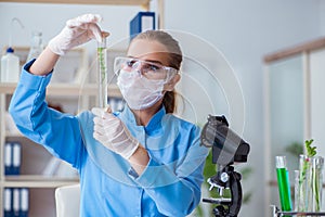 Female scientist researcher conducting an experiment in a labora