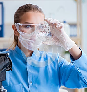 Female scientist researcher conducting an experiment in a labora