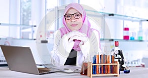 Female scientist smiling in laboratory