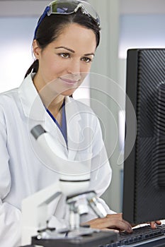 Female Scientist Using Computer In Laboratory