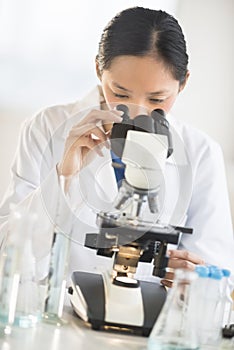 Female Scientist Using Microscope