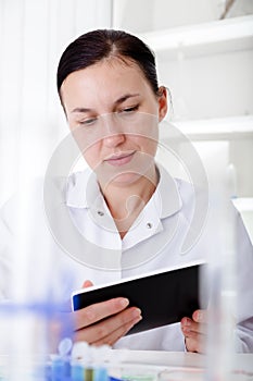 Female Scientist Using Tablet In Laboratory