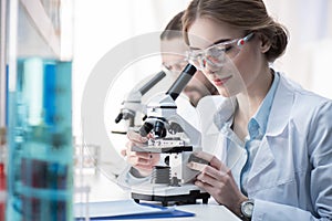 Female scientist working with microscope
