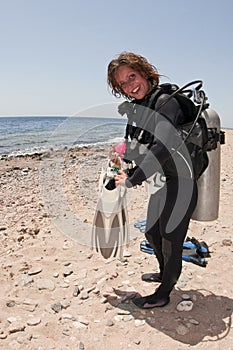 Female scuba diver on beach