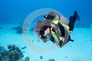 Female scuba diver swimming under the sea