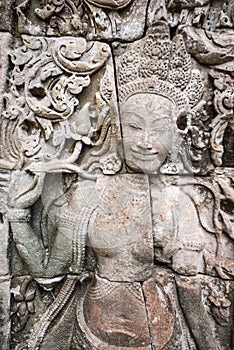 Female sculpture on the facade of Angkor Thom Bayon, Angkor. Cambodia