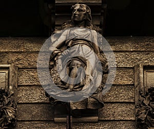 Female sculpture on the facade photo
