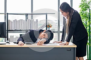 Female secretary awakens the boss to sleep on the work desk photo