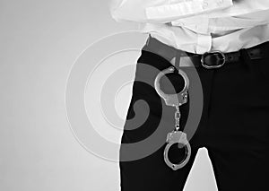 Female security guard with handcuffs on color background